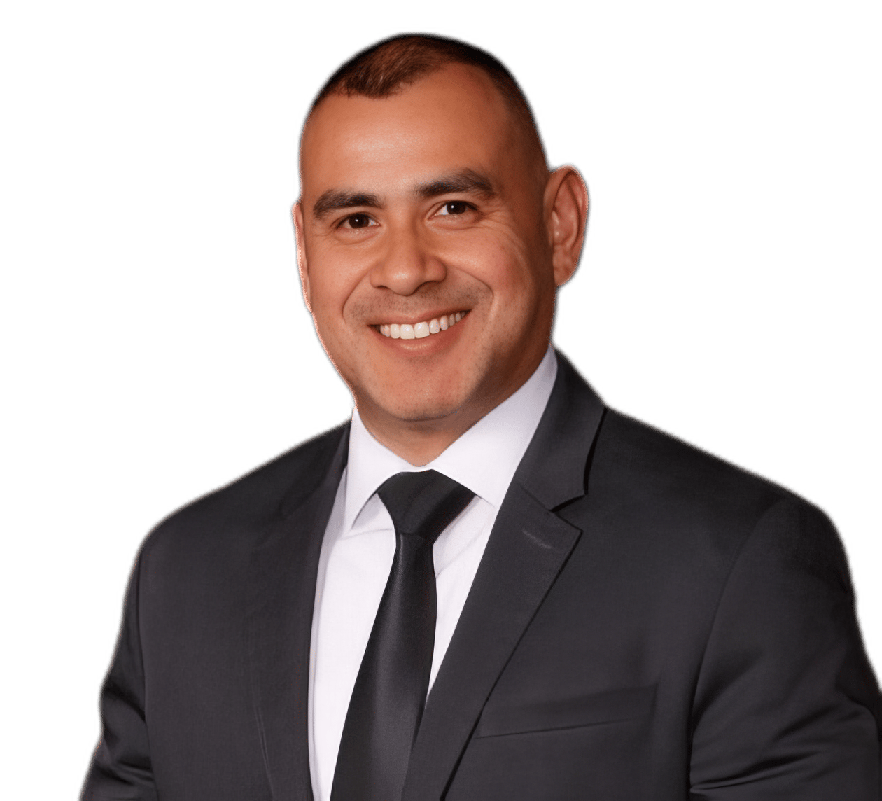 Jose Salazar smiling in a black suit and tie.