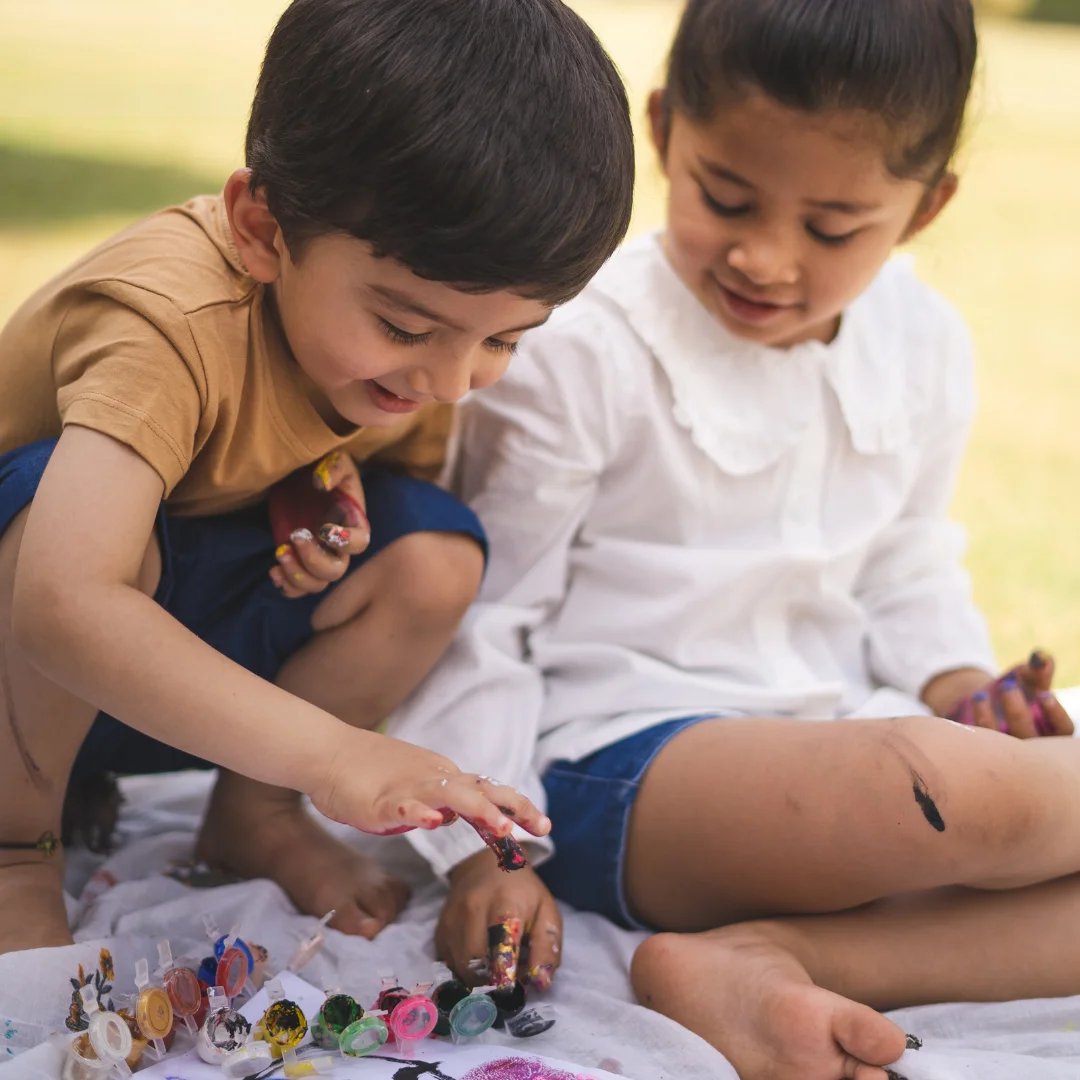 Children enjoying watercolor painting activities at Umlauf Sculpture Garden family day