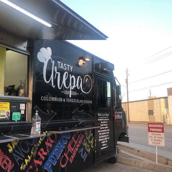 Tasty Arepa food truck with an open service window and Colombian and Venezuelan cuisine signage.