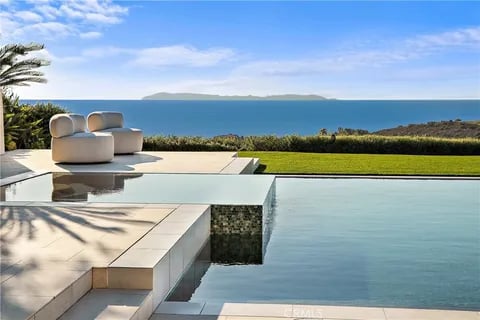 Multimillion-dollar waterfront estate in Newport Beach, California during golden hour, representing the best time to list a luxury coastal home