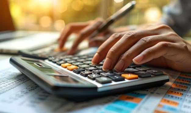 Hands use a calculator on financial papers beside a pen.