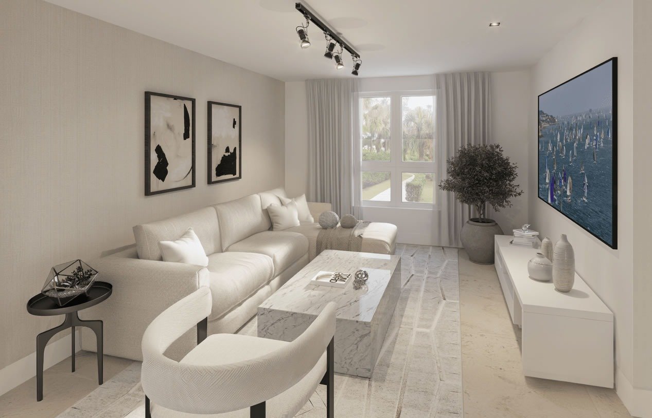 Living room with a cream sectional, marble coffee table, and tall windows overlooking greenery.
