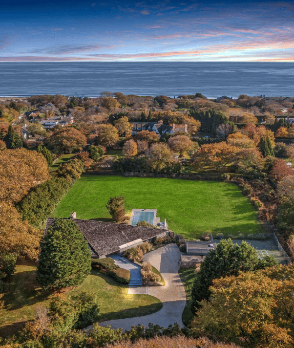 Aerial view of a luxury beachfront estate in the Hamptons, New York, showcasing prime ultra-luxury coastal property.