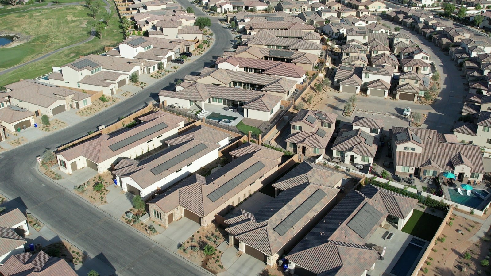 Aerial view of PGA West homes, community streets, and nearby golf course in La Quinta, California