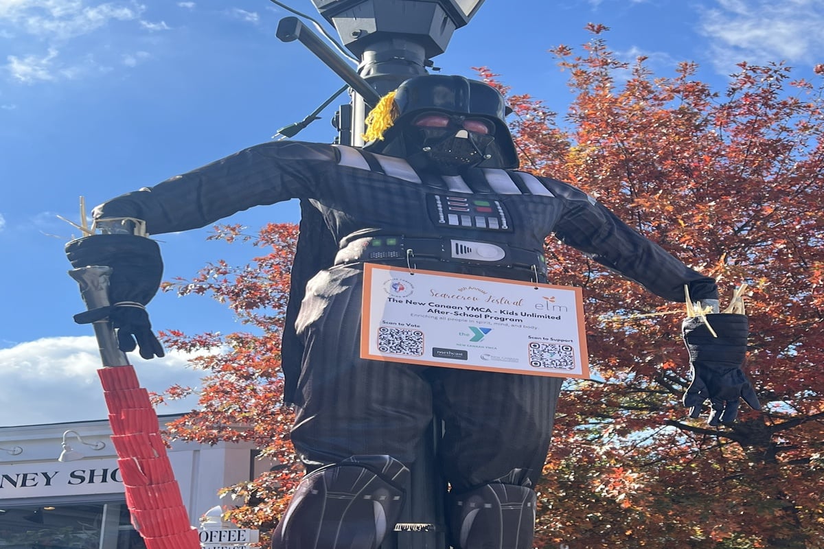 Decorative scarecrows line Main Street in downtown New Canaan, Connecticut during the annual Scarecrow Festival — a beloved community event that highlights the town’s festive fall charm and small-town spirit.