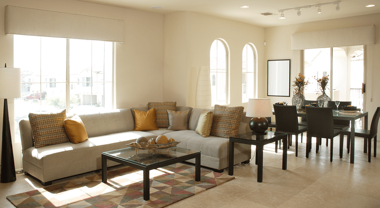 A cozy living room featuring a comfortable couch, a stylish table, and inviting chairs arranged for relaxation.