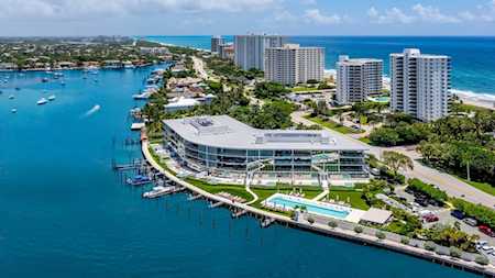Waterfront condominium complex with a marina, pool, and Atlantic coastline beyond.