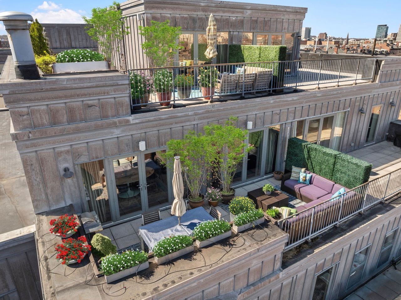 This exceptional South End Boston penthouse duplex redefines luxury living with striking modern design, panoramic skyline views, and expansive multi-level terraces!