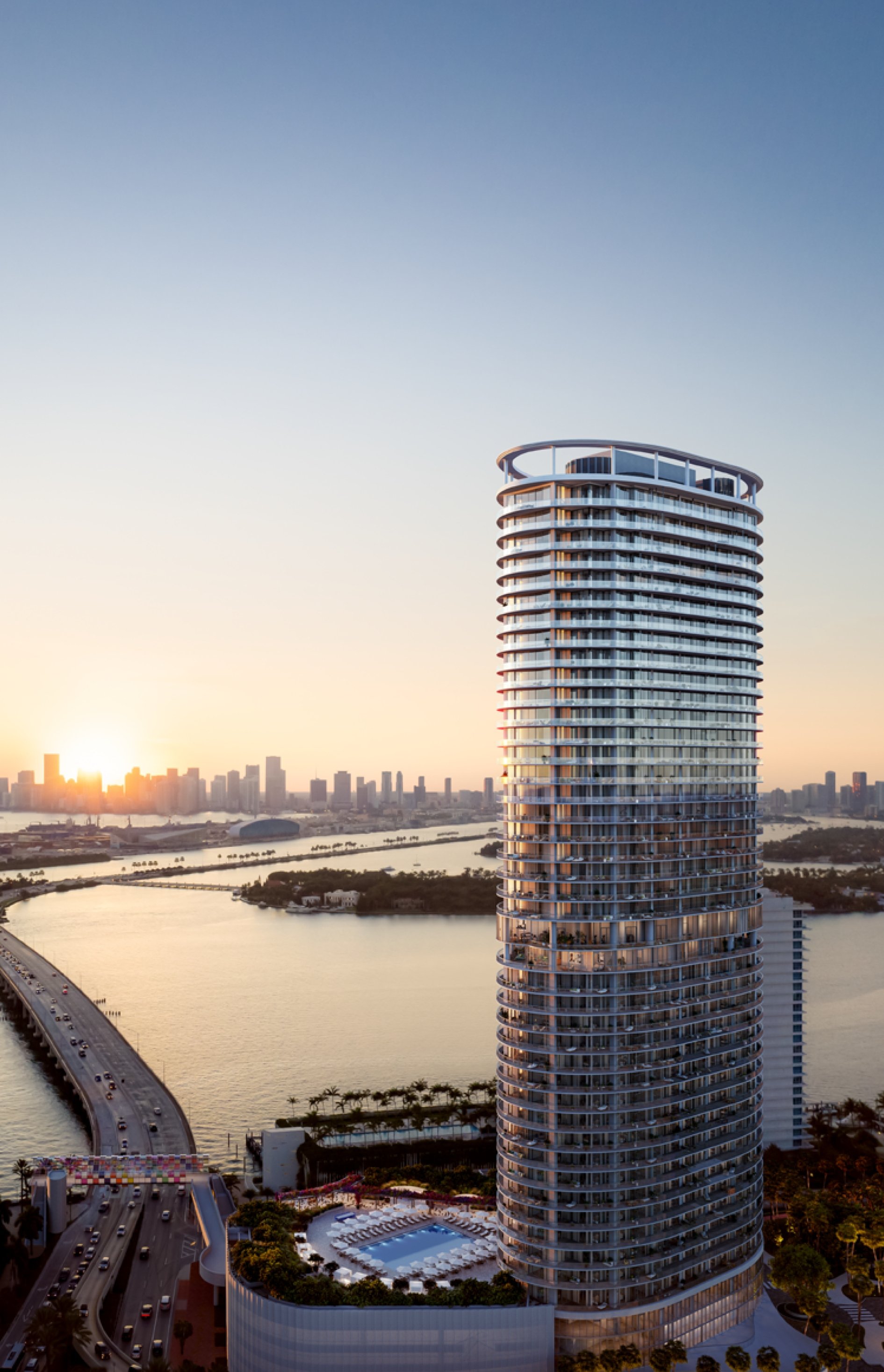Rendering of Five Park Miami Beach over Biscayne Bay with its rooftop ring and pool terrace at sunset