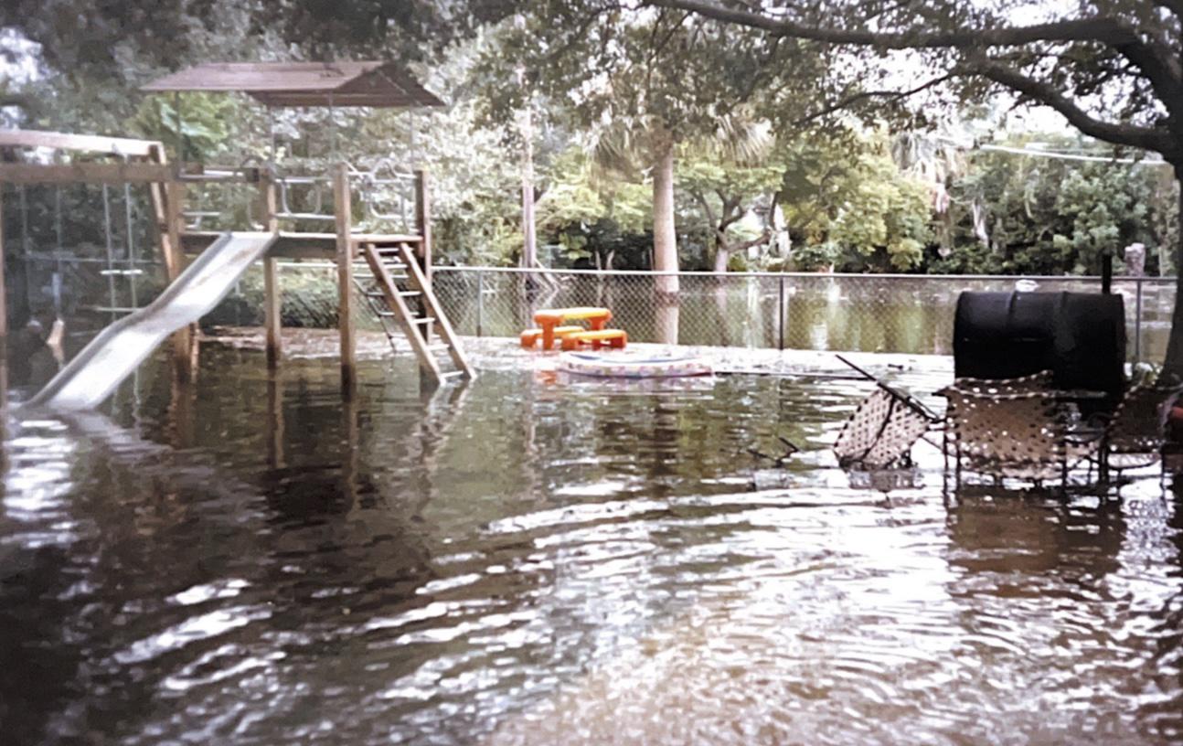 A backyard swing set and slide partially submerged after flooding at a South Tampa home.
