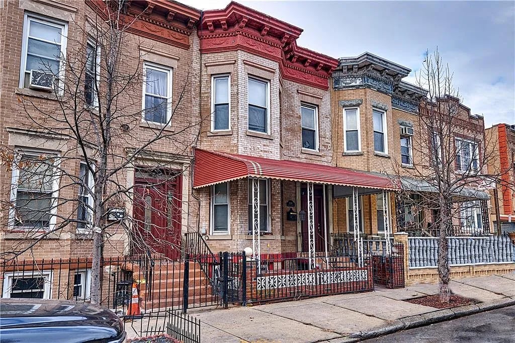 Exterior of 1339 Decatur St Bushwick Brooklyn a 2-family brick townhouse sold by The Parviz Team at Compass.