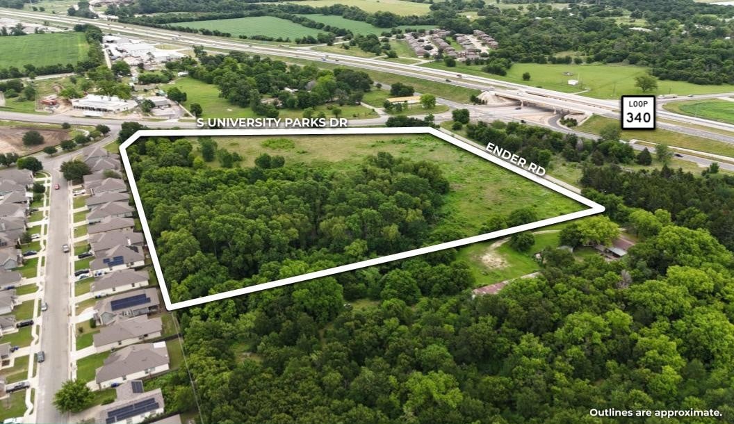 Aerial view of a wooded land parcel outlined along S University Parks Drive and Ender Road.