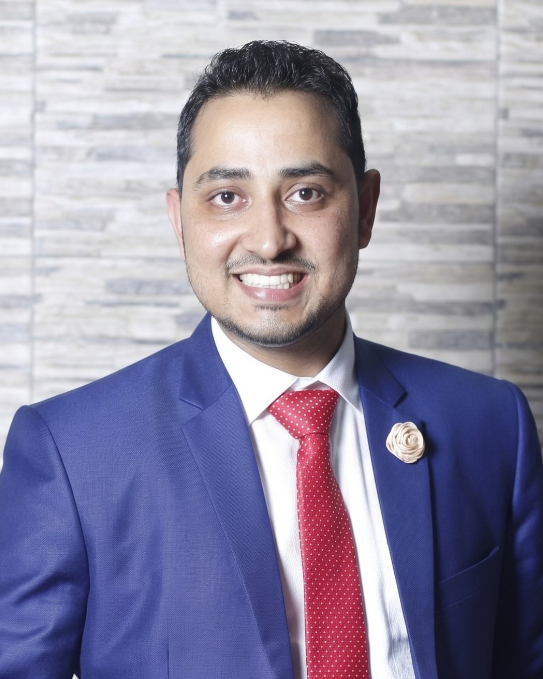 MD Sahidul Alam in a blue suit and red tie.