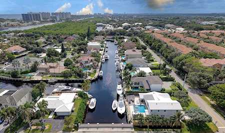 Aerial view of an East Boca canal lined with waterfront homes, docks, and boats.