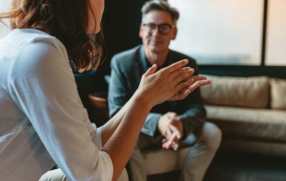 A seller and their real estate agent talking before listing their home for sale Inner City Calgary 
