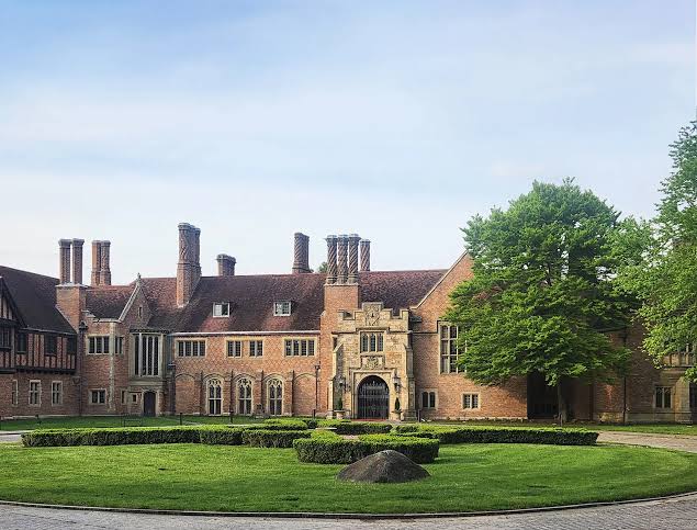 Meadow Brook Hall, a Tudor Revival mansion with a formal lawn and clipped hedges.