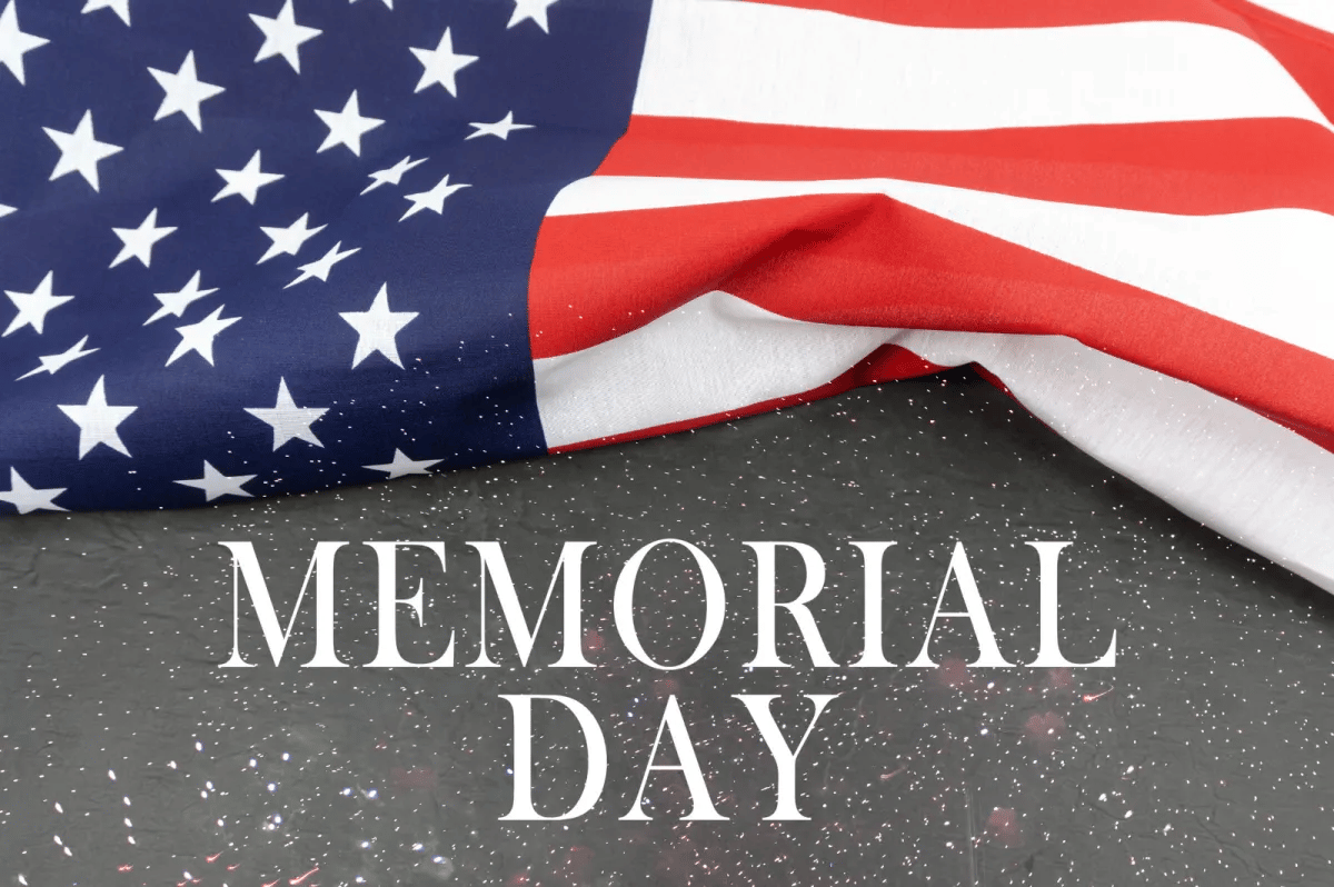 Draped American flag above the words “MEMORIAL DAY.”