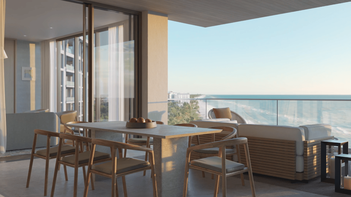 Furnished balcony with outdoor dining and lounge seating overlooking the Gulf.