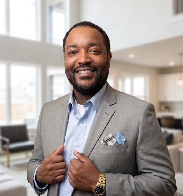 Jason Jemison smiling in a gray suit jacket and light blue shirt.