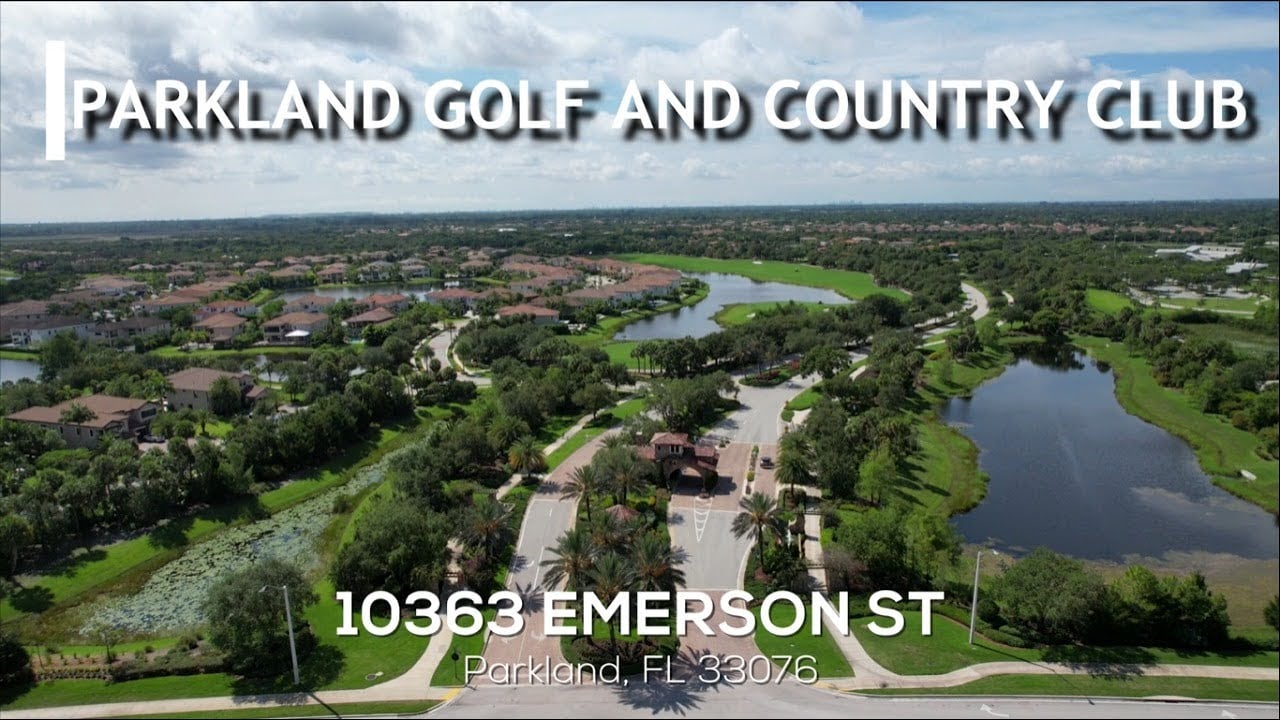 Aerial view of Parkland Golf and Country Club, with homes, lakes, and a landscaped entrance.