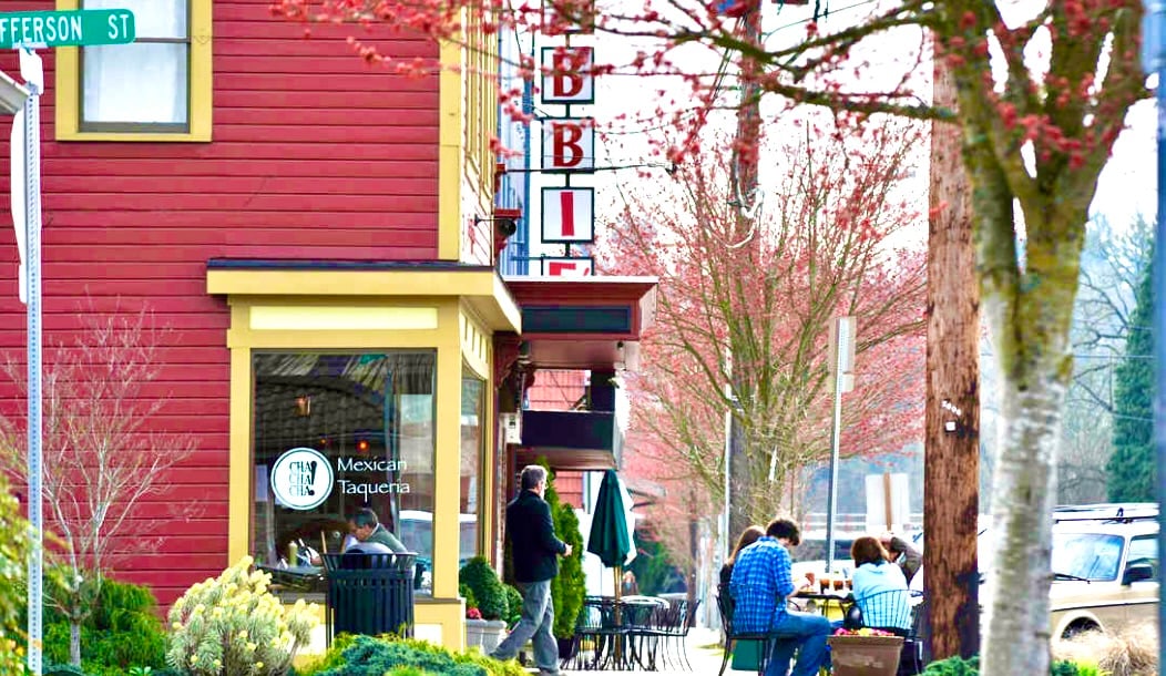 Downtown Jefferson Street cafe with outdoor seating beneath flowering trees.