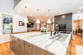 Modern kitchen and dining area with white cabinetry and marble flooring, highlighting the architectural integrity of luxury properties in Roseville and Granite Bay.