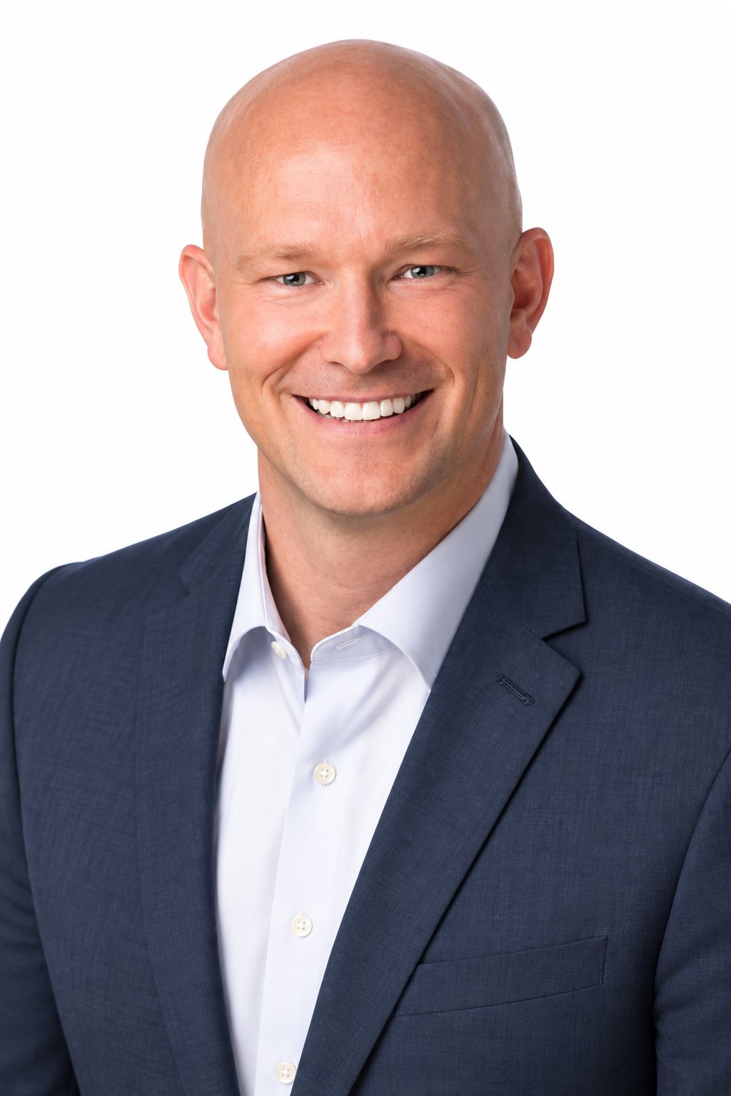 Smiling bald man in a navy suit and white shirt