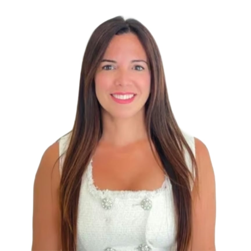 Cristina Blanco, real estate agent, wearing a white sleeveless top.