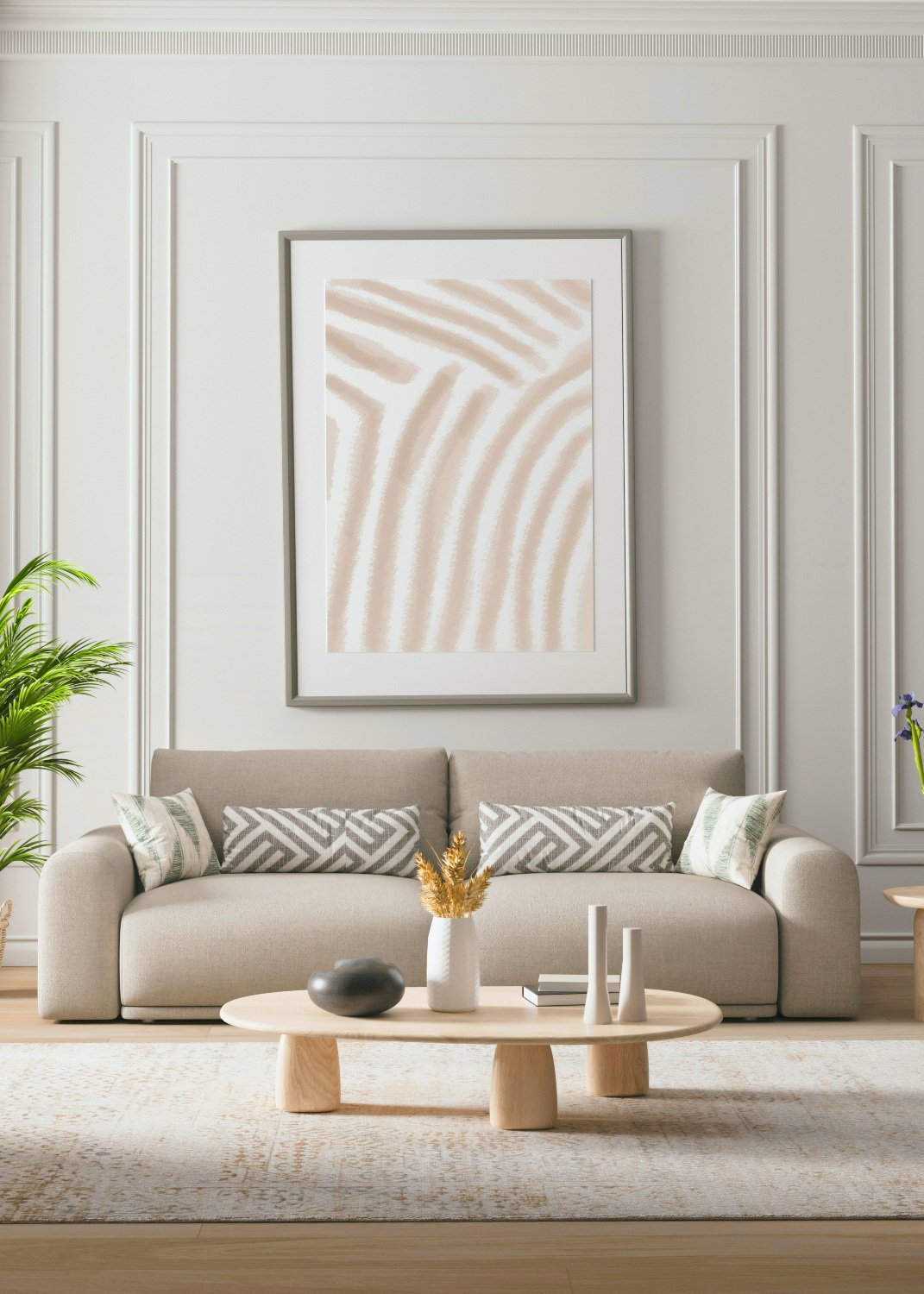 Staged living room with a beige sofa, patterned pillows, and framed abstract art.