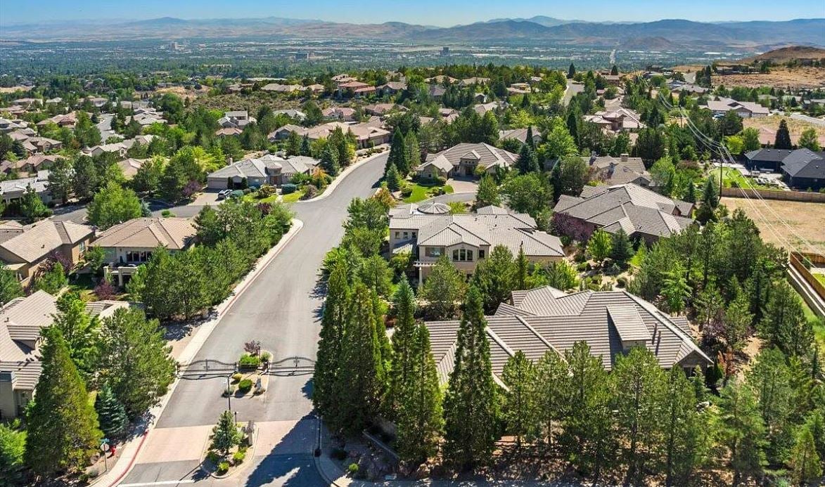 Welcome to Mountainshyre at Caughlin Ranch—Reno's premier gated enclave nestled in the scenic foothills, just minutes from everything yet worlds away in feel! This elegant single-story residence offers luxury, space, and serenity on a beautifully manicured 0.41-acre lot. Inside, you'll find a thoughtfully designed layout with 4 spacious bedrooms, a dedicated office, two living areas, and formal dining—ideal for both everyday living and entertaining. Soaring ceilings, natural light, and travertine flooring create an airy, sophisticated atmosphere.