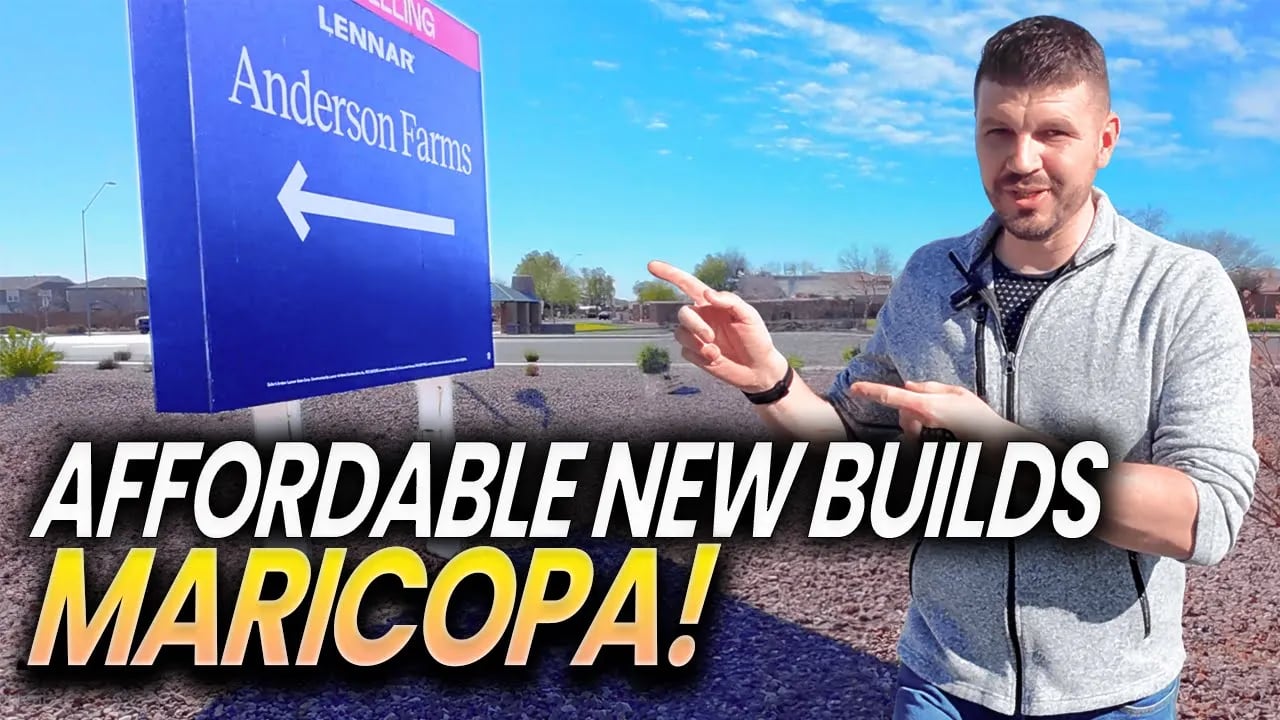 Affordable new builds in Maricopa; a man points toward the Anderson Farms sign.