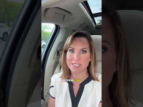 Melissa Infanzon seated in a car, speaking to the camera beneath a panoramic glass roof.