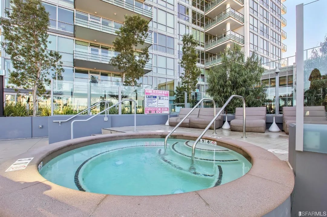 Arden Residences rooftop hot tub with a view of the building.