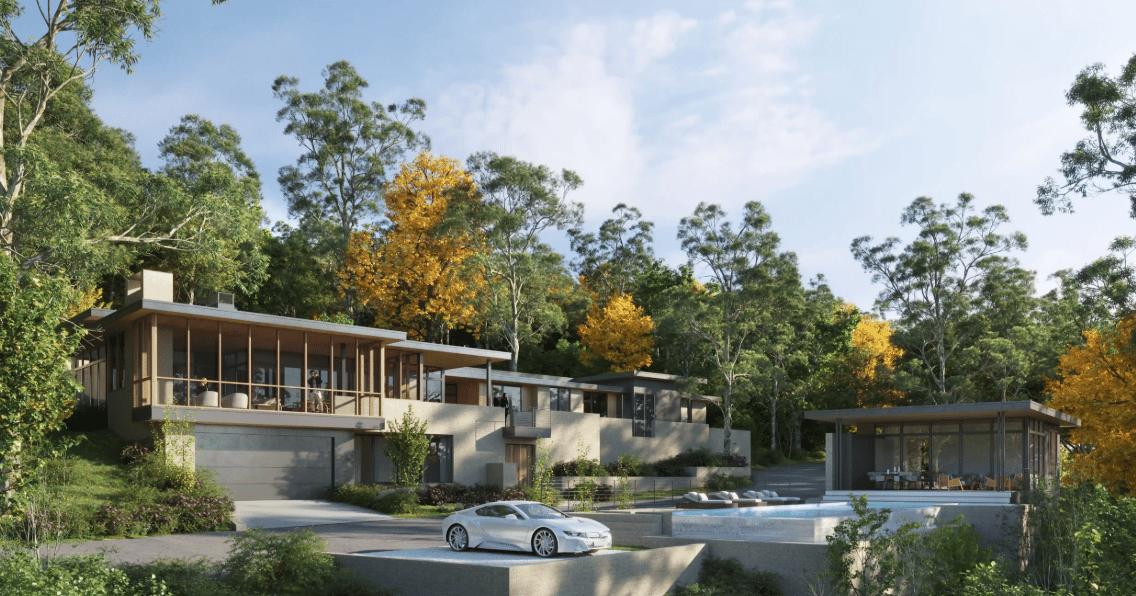 Modern home with broad glass frontage, swimming pool, and detached pavilion amid autumn trees.