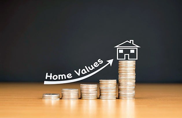 Home values rise above increasing stacks of coins, marked by an upward arrow and house drawing.
