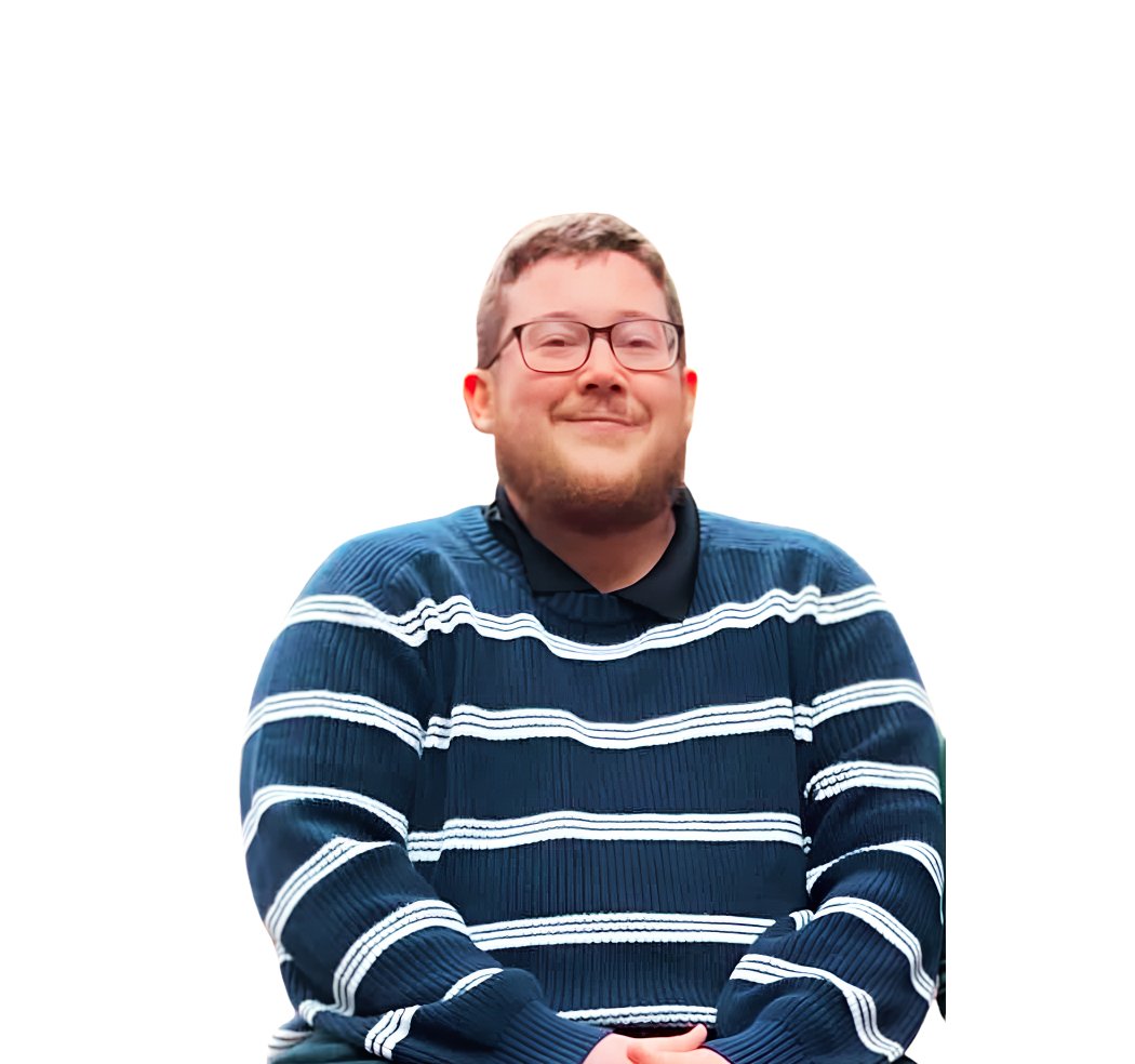 Matthew McDonald wearing glasses and a navy sweater with white stripes.