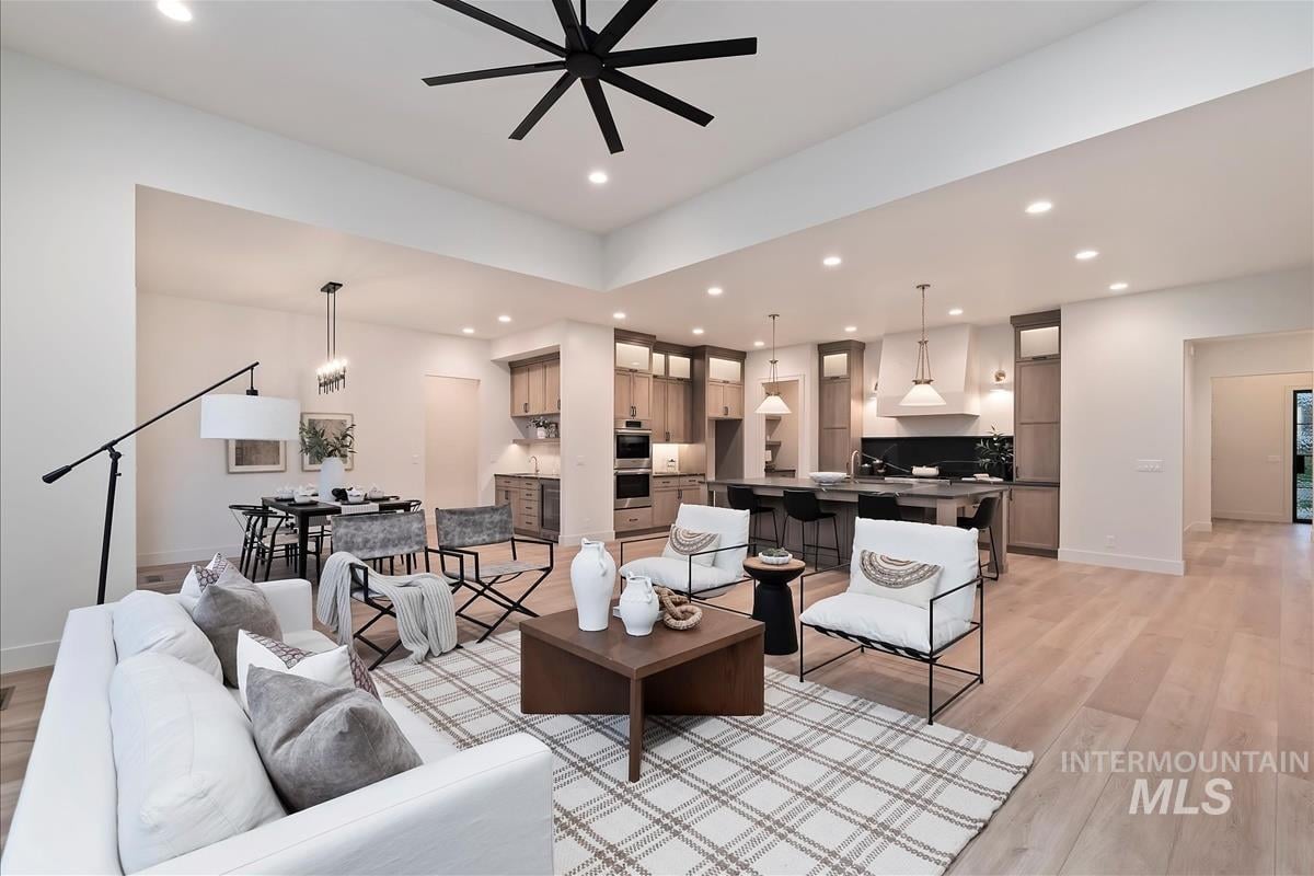 Wide angle shot of a living room, dining room, kitchen, butler pantry and hallway to the entrance