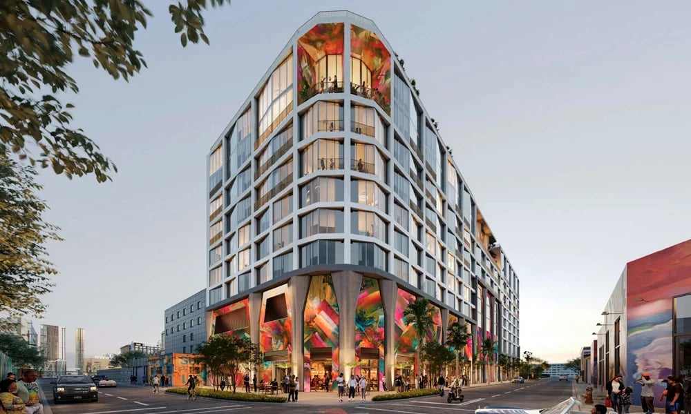 The Cloud One Residences, a glass tower with colorful artwork across its ground-floor facade.
