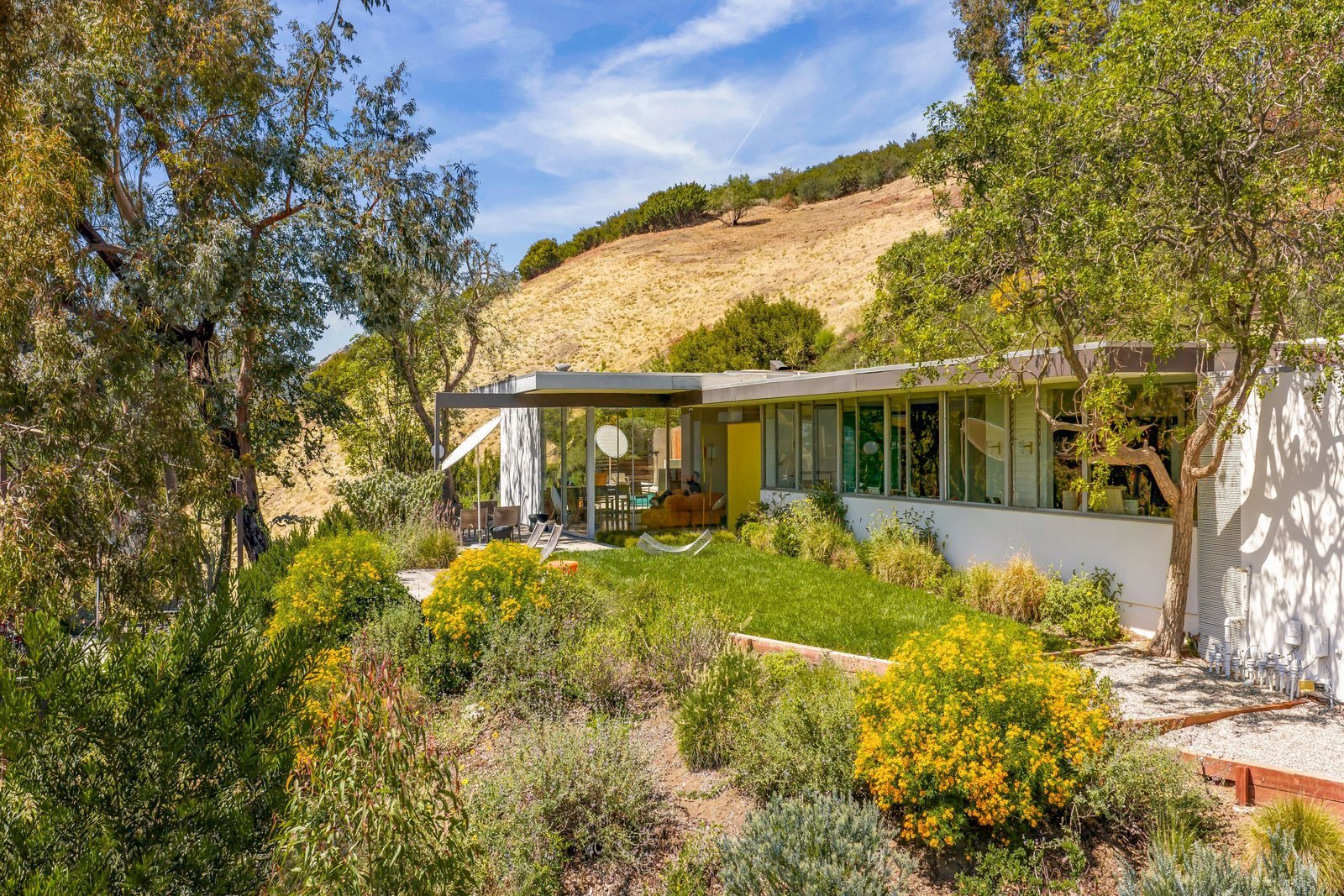 The Sale House by Richard Neutra, a low horizontal glass-and-steel residence set into a Brentwood hillside.