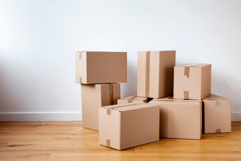 Stacked moving boxes inside a home representing relocation planning when moving to the Raleigh area