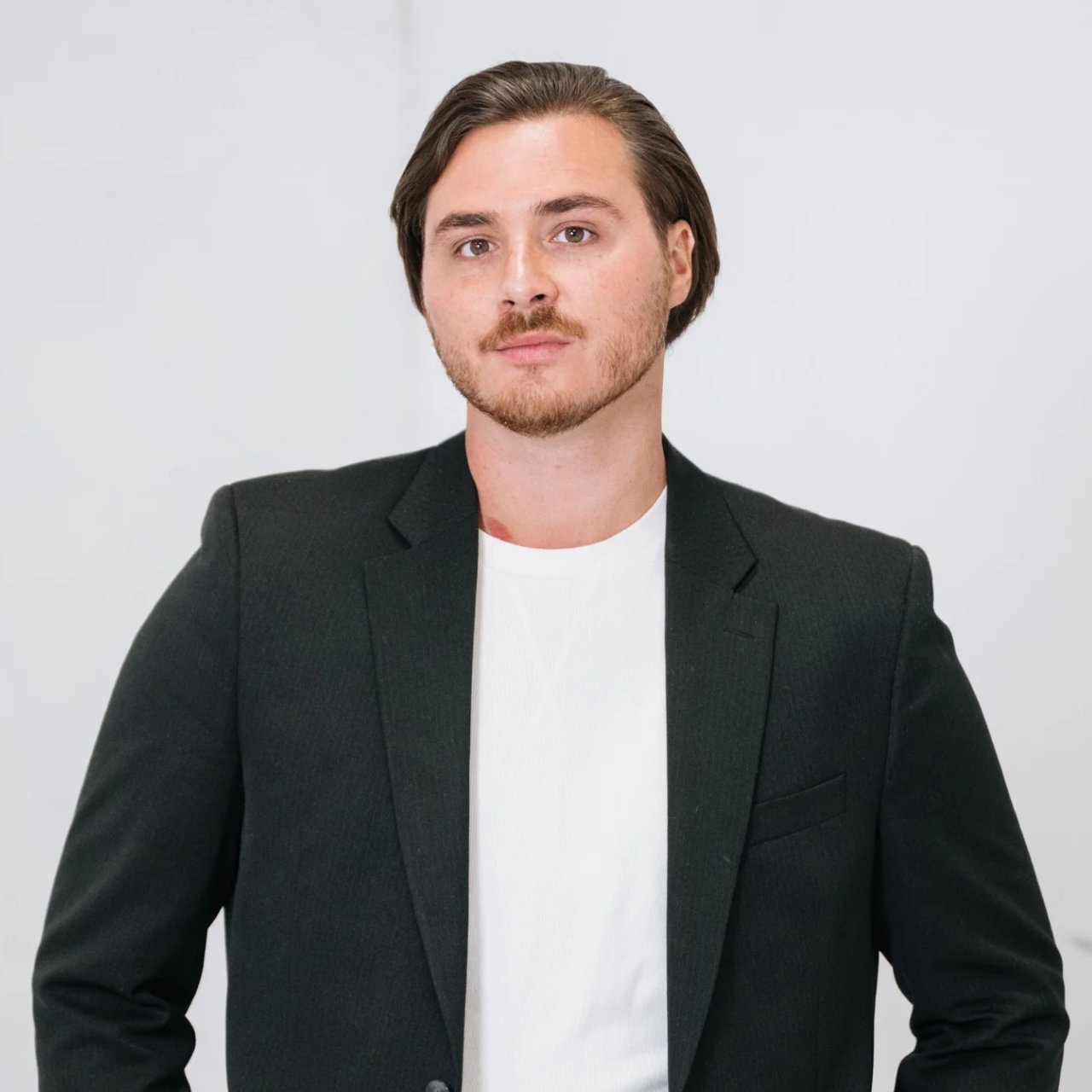 Justin Schmieder in a dark blazer and white shirt.