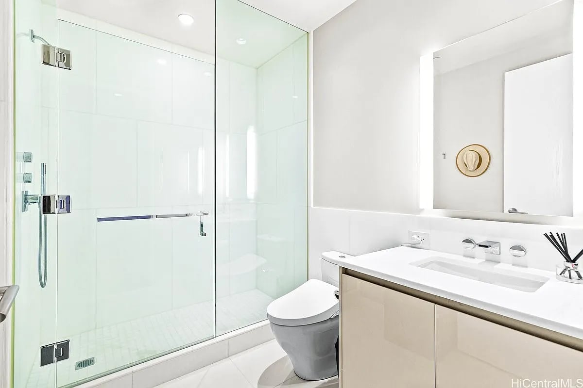 Modern bathroom with a glass-enclosed shower and wide vanity.