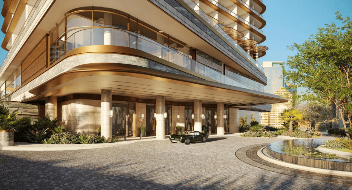 Luxury condo entrance with curved balconies, landscaped grounds, and a reflecting pool.