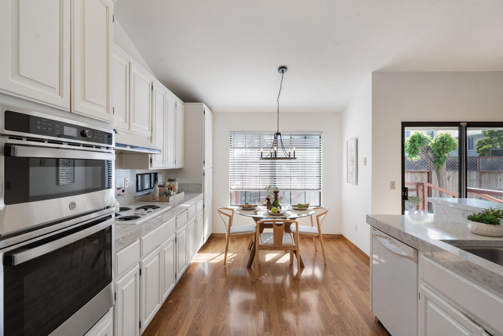 Kitchen with seated breakfast bar and open flow to living space in Petaluma home