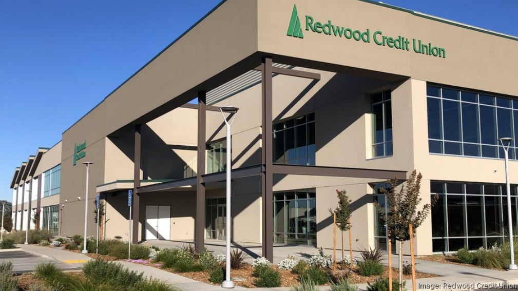 Redwood Credit Union branch with large glass windows and a landscaped entrance.