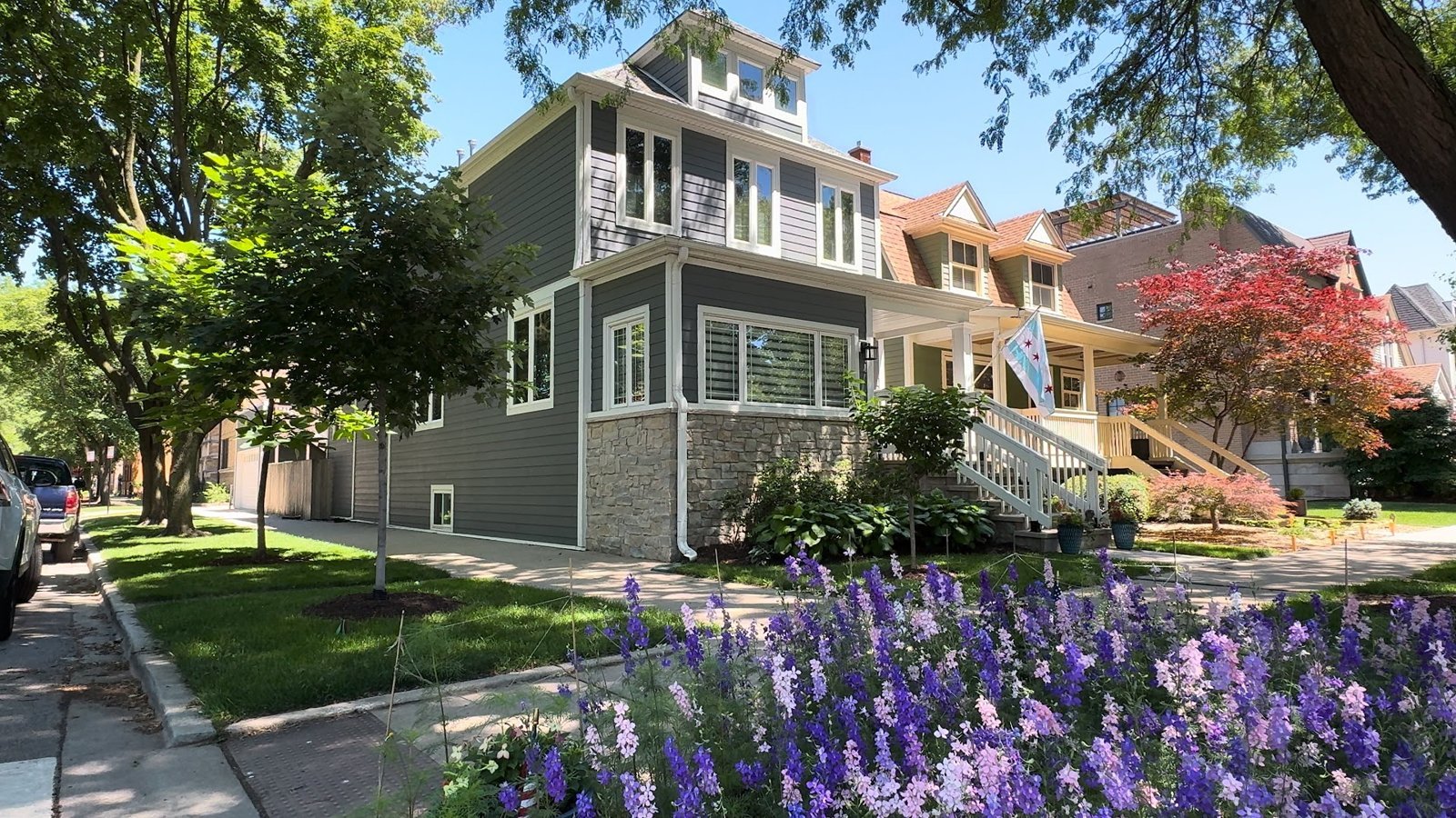 Gray frame house with a front porch on a tree-lined street in North Center, Chicago