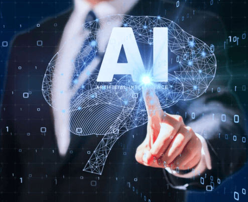 Artificial intelligence concept with a glowing wireframe brain and a hand reaching toward a digital interface.