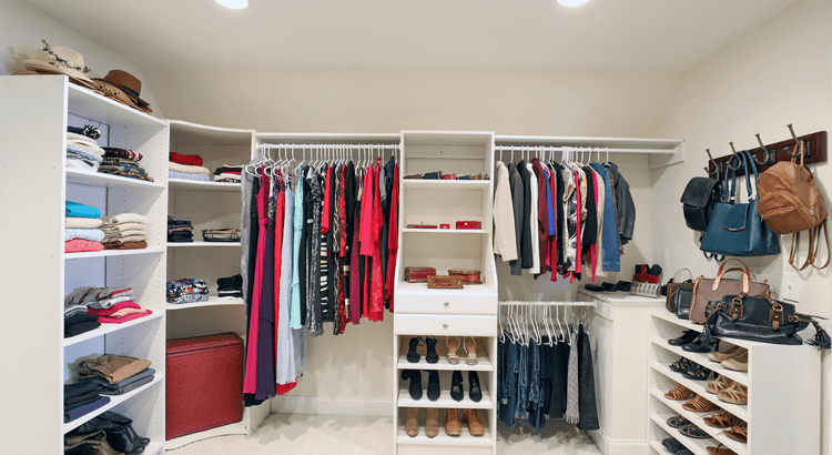 Organized walk-in closet with shelves, hanging clothes, shoes, and handbags, showcasing home upgrades that boost value.