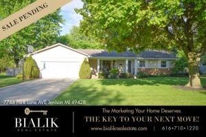 Single-story home with an attached garage, broad lawn, mature trees, and a “Sale Pending” banner.