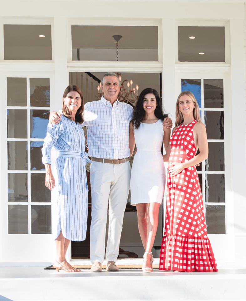 Hosts greeting guests in front of the French doors